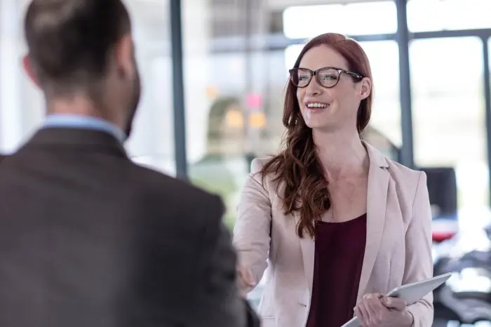 business people shaking hands in office