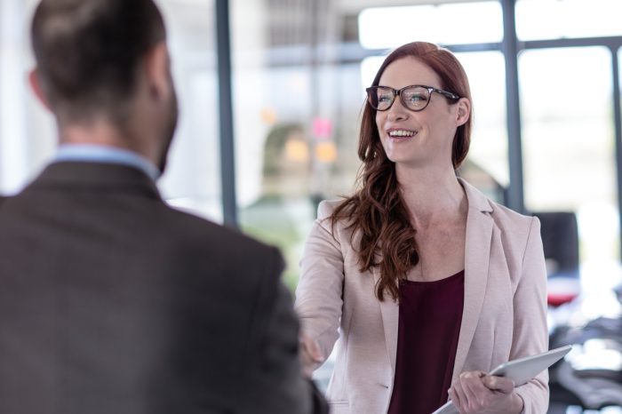 business people shaking hands in office