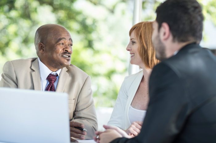 businesspeople discussing work at business lunch