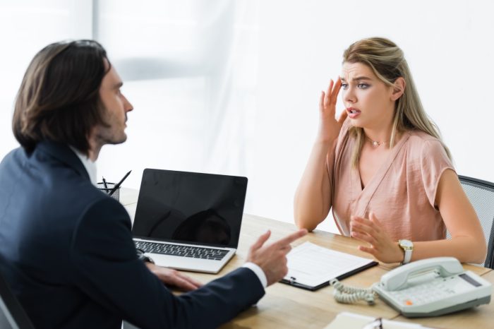 upset woman sitting in office and talking
