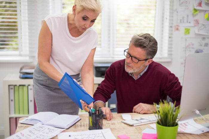 woman standing next to the manager s desk